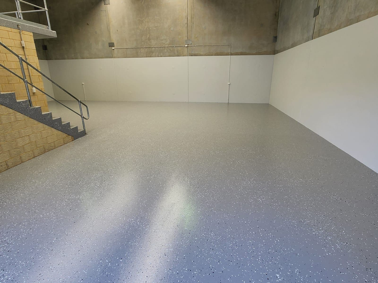 Epoxy floor with staircase and handrail