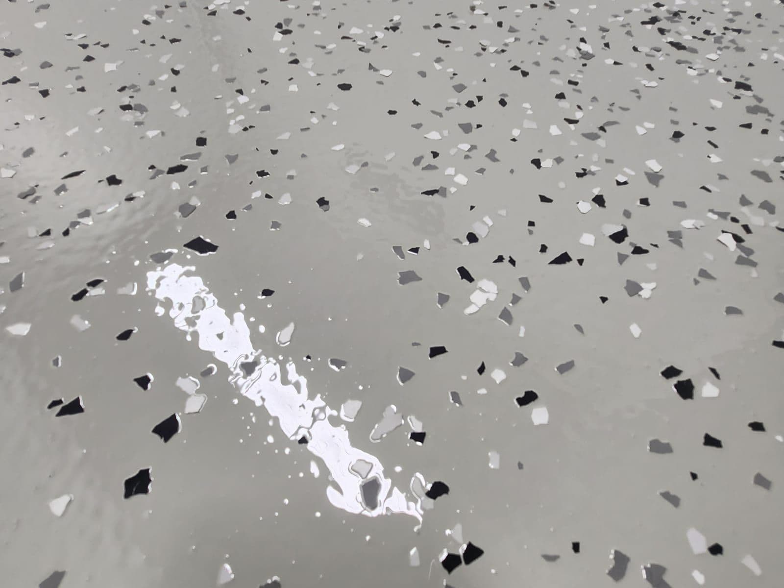 Metallic flake epoxy garage floor with silver and black flakes