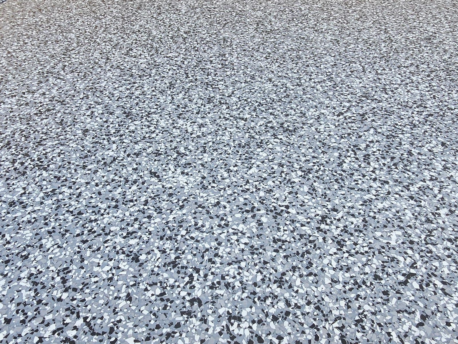 Flake epoxy floor beneath a staircase