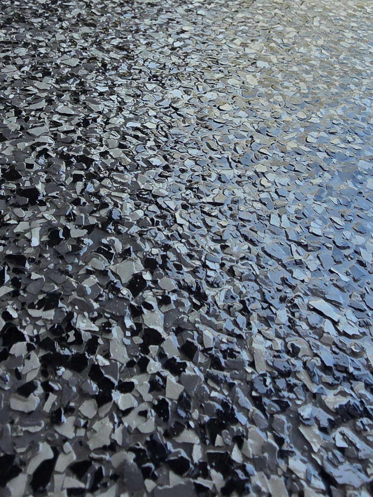 Dark flake epoxy floor with dense black and grey flake broadcast