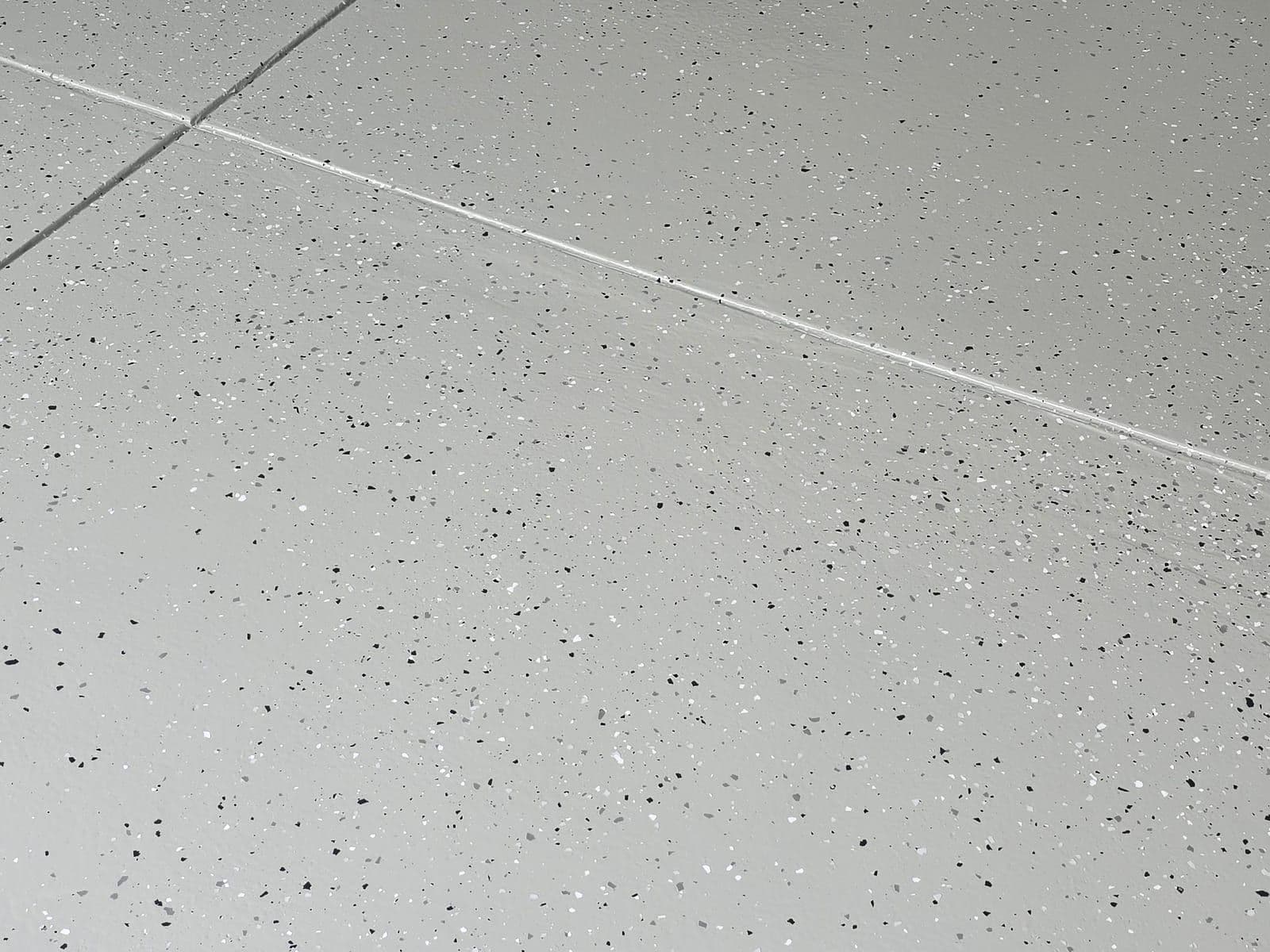 Light grey flake epoxy floor in a covered outdoor area