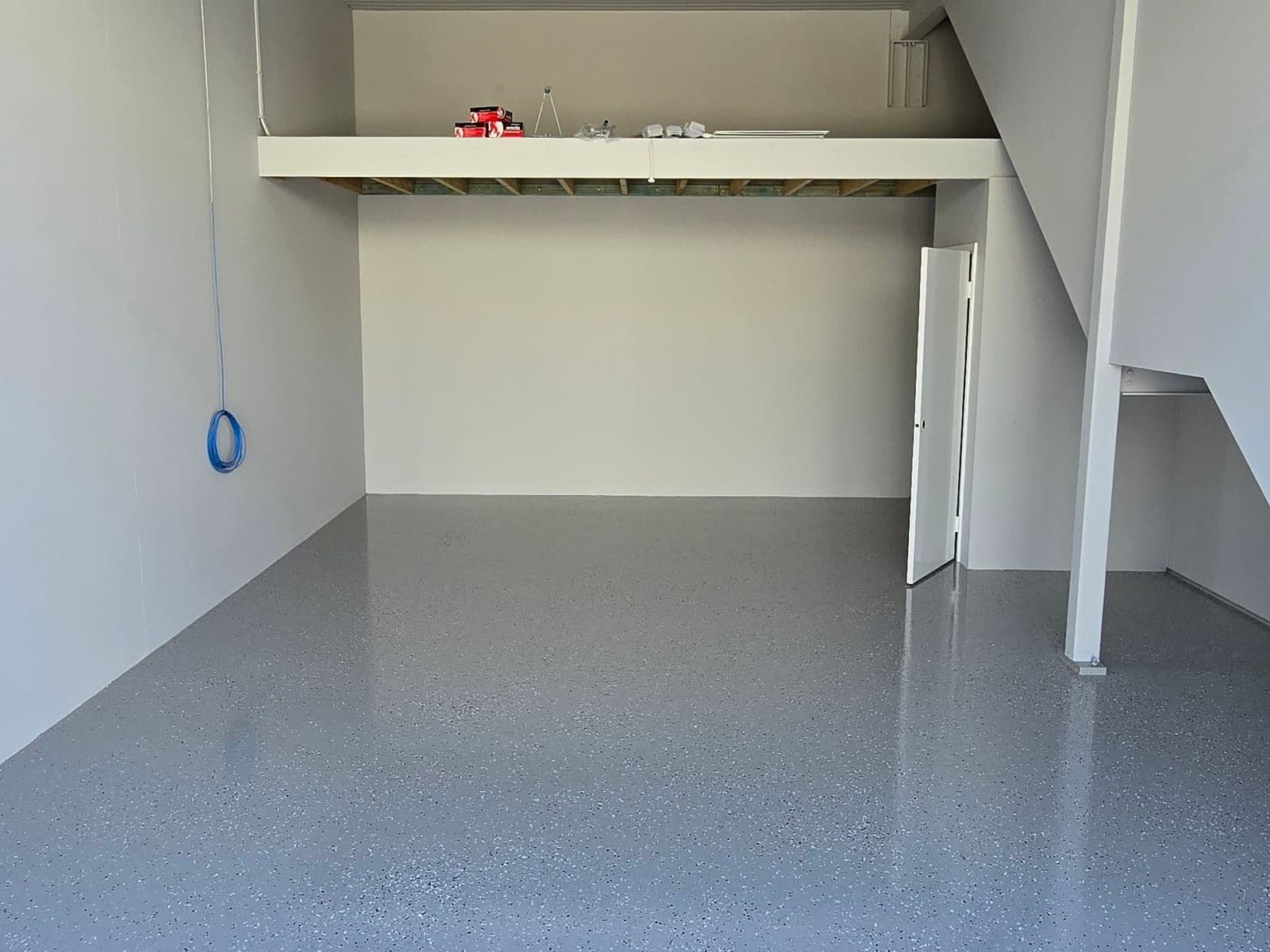 Flake epoxy floor in a workshop with overhead lighting
